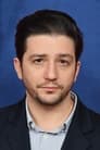 John Magaro isGeoffrey Mason